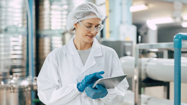 Happy senior science staff women worker work control quality of water in drinking water plant using tablet to record jobs